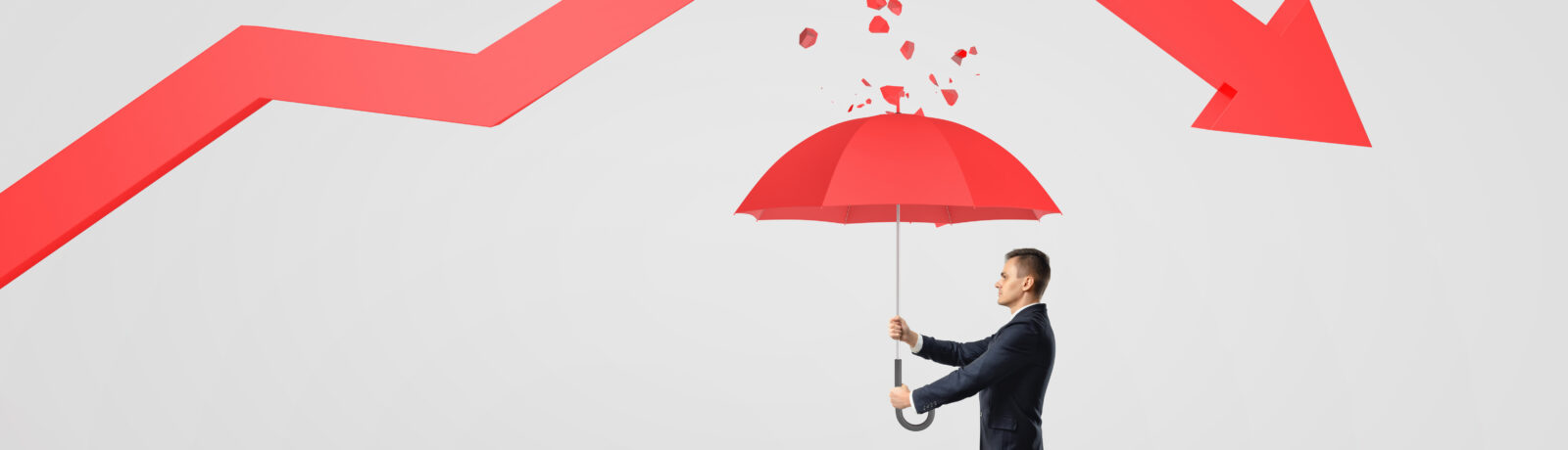 Businessman protecting himself from a broken statistical trendline with an umbrella.