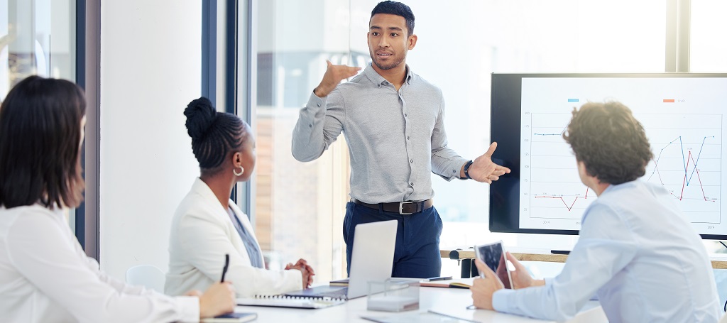 Photo of a manager speaking at a team meeting.